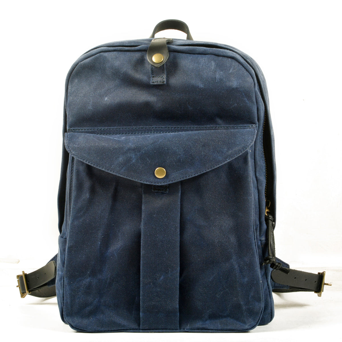 Navy waxed vintage canvas school backpack with a snap front pocket and leather top handle