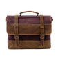 Red canvas messenger bag with a leather top handle, flap and front straps
