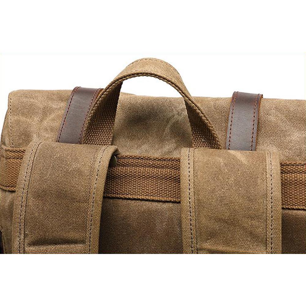 Close-up of the leather-wrapped top handle on the khaki rucksack