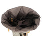 Open roll top compartment with a gray lining and inner slot pockets
