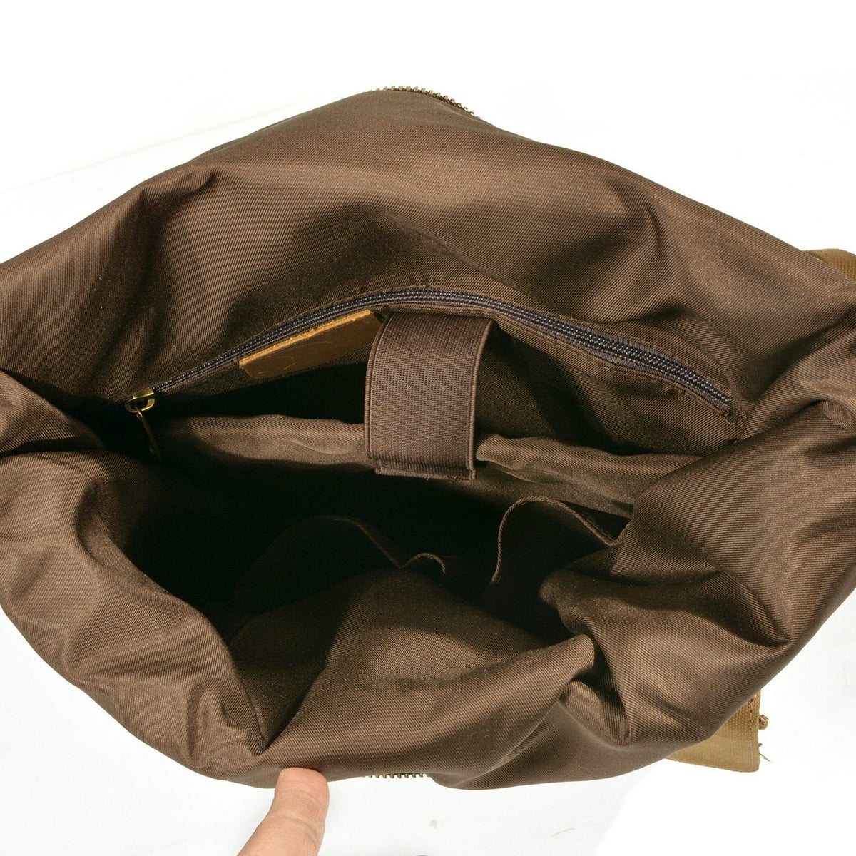 Brown lining and inner pocket inside the roll top compartment