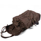 Coffee waxed canvas backpack opened at the drawstring top, showing its empty interior.