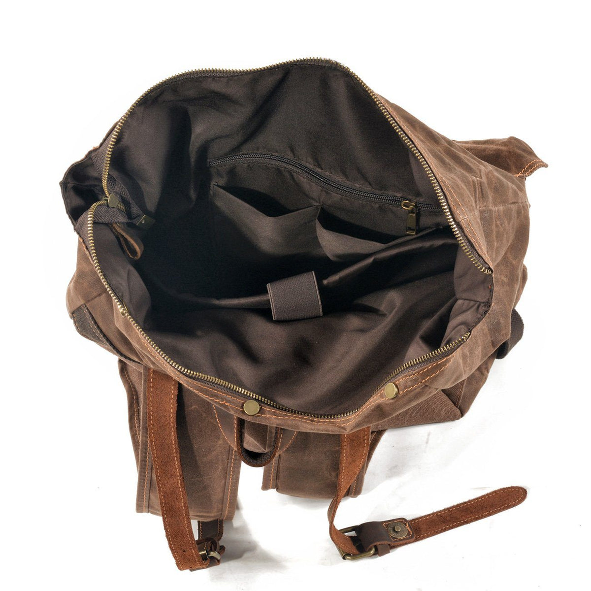 Open interior of coffee waxed canvas backpack with dark lining, padded laptop sleeve and organizer pockets.