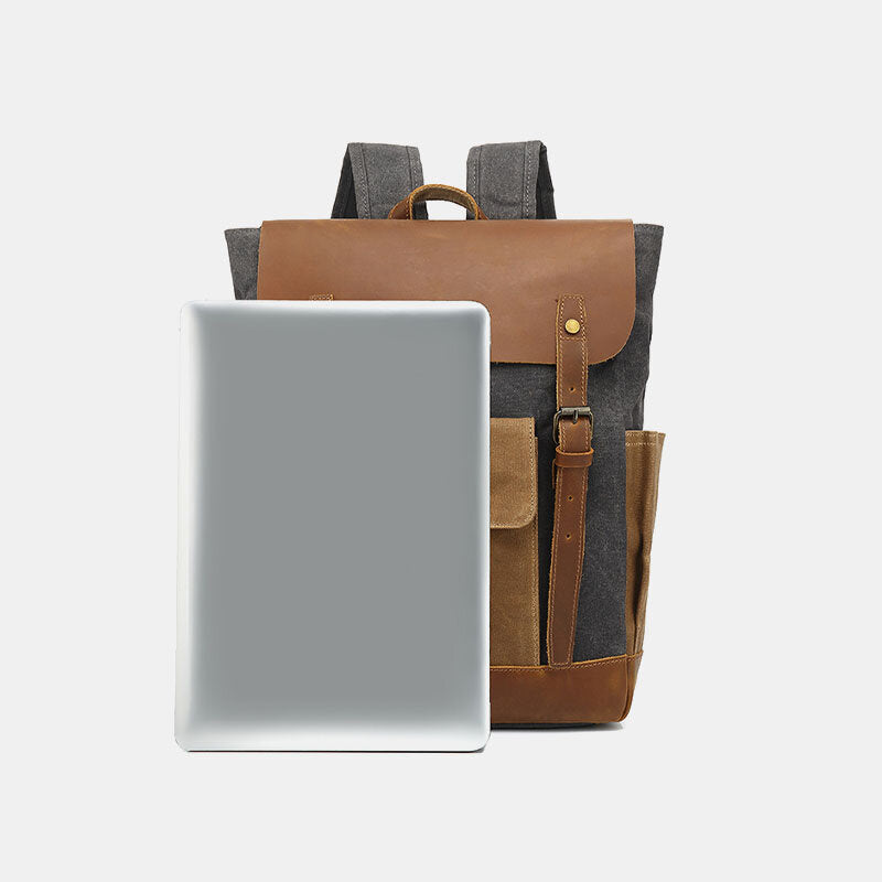 Waxed canvas laptop backpack shown beside a laptop for size comparison