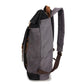Left-side view of the Black roll top backpack with its padded shoulder strap.