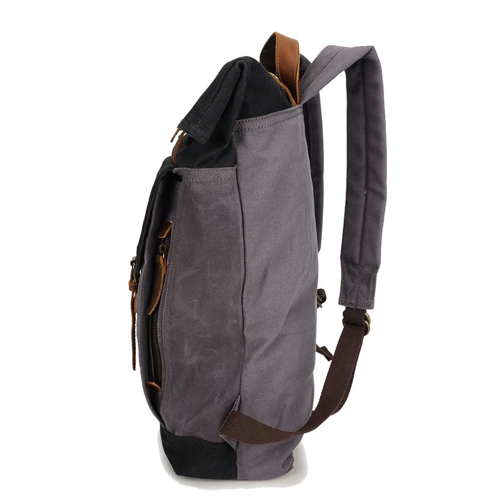 Left-side view of the Black roll top backpack with its padded shoulder strap.