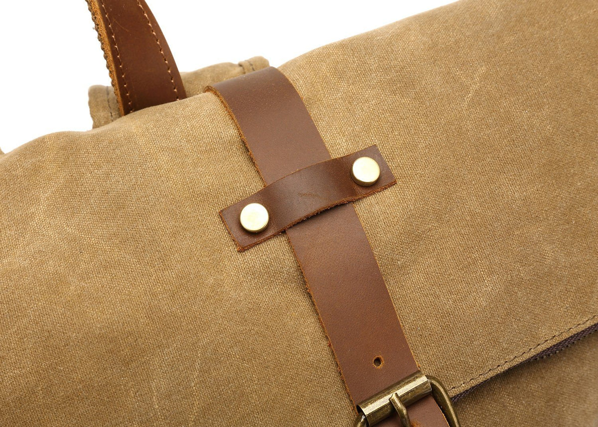 Leather strap and brass buckle across the rolled top