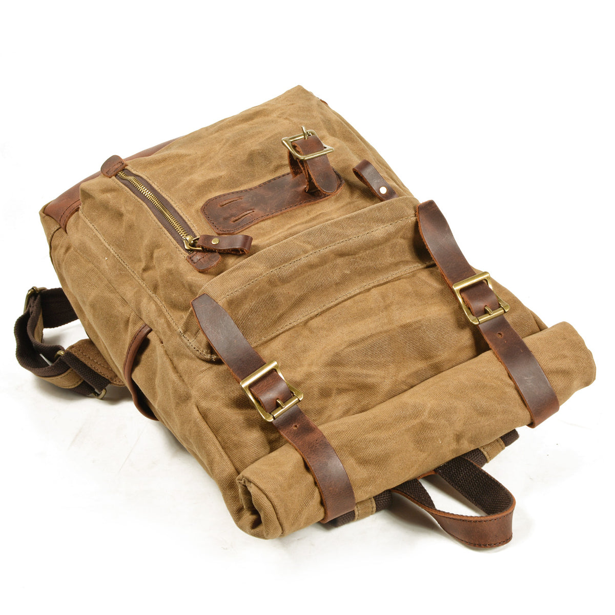 Backpack lying flat with its buckled straps and front zipper pocket visible