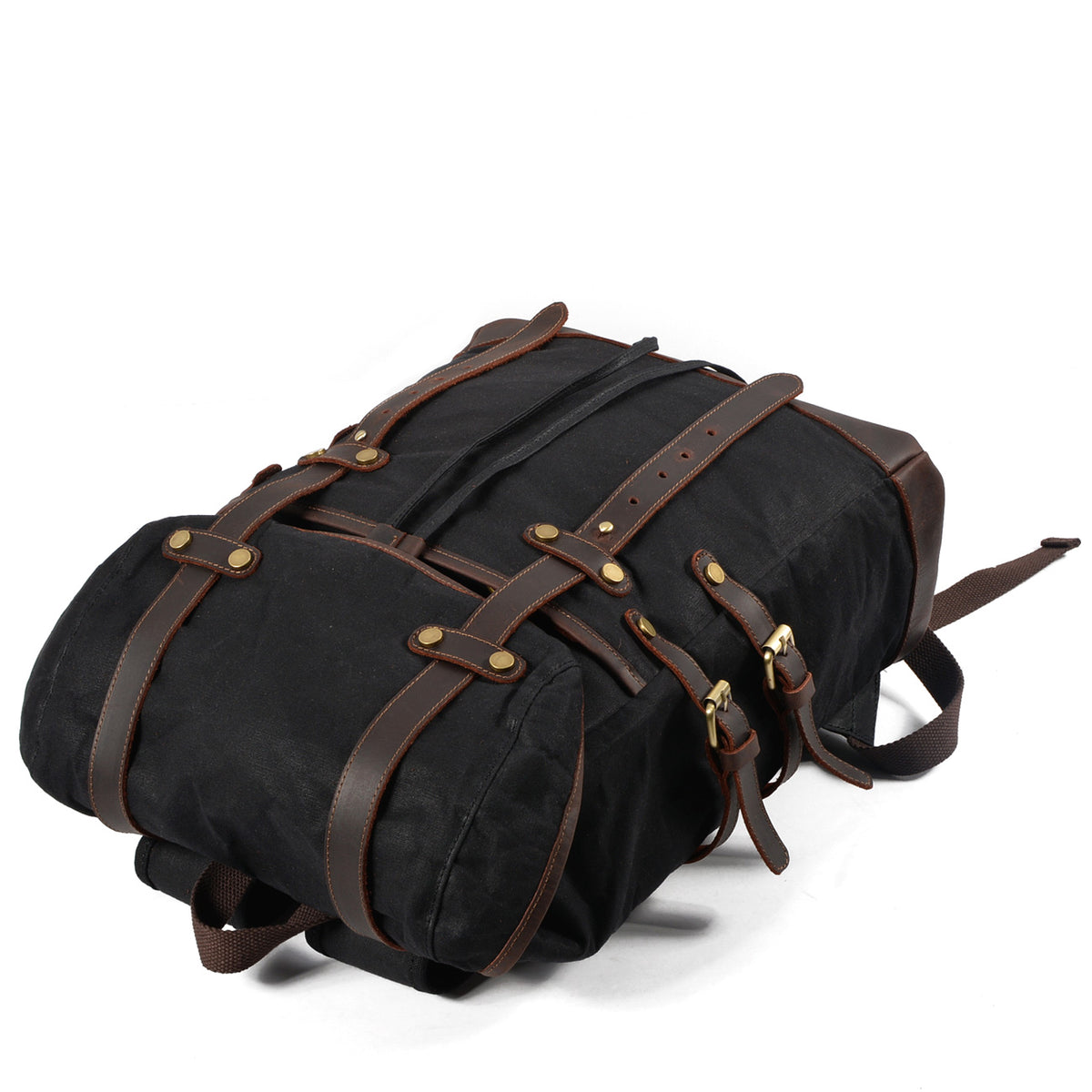 Black rucksack lying flat to show the leather strap layout