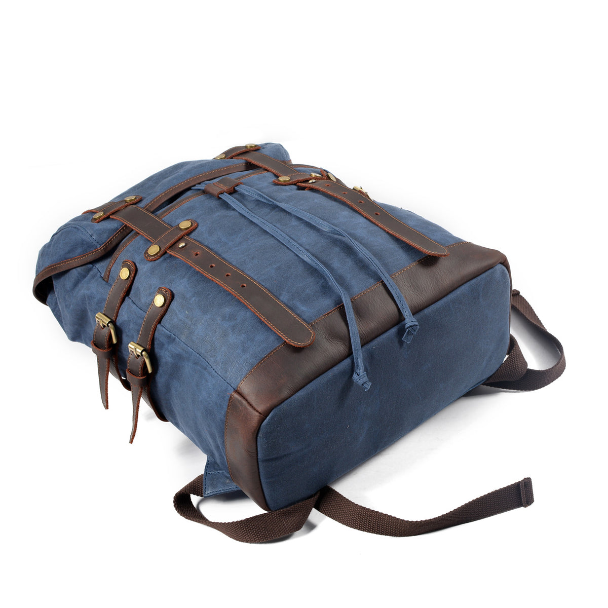 Blue waxed canvas backpack lying flat with straps fastened