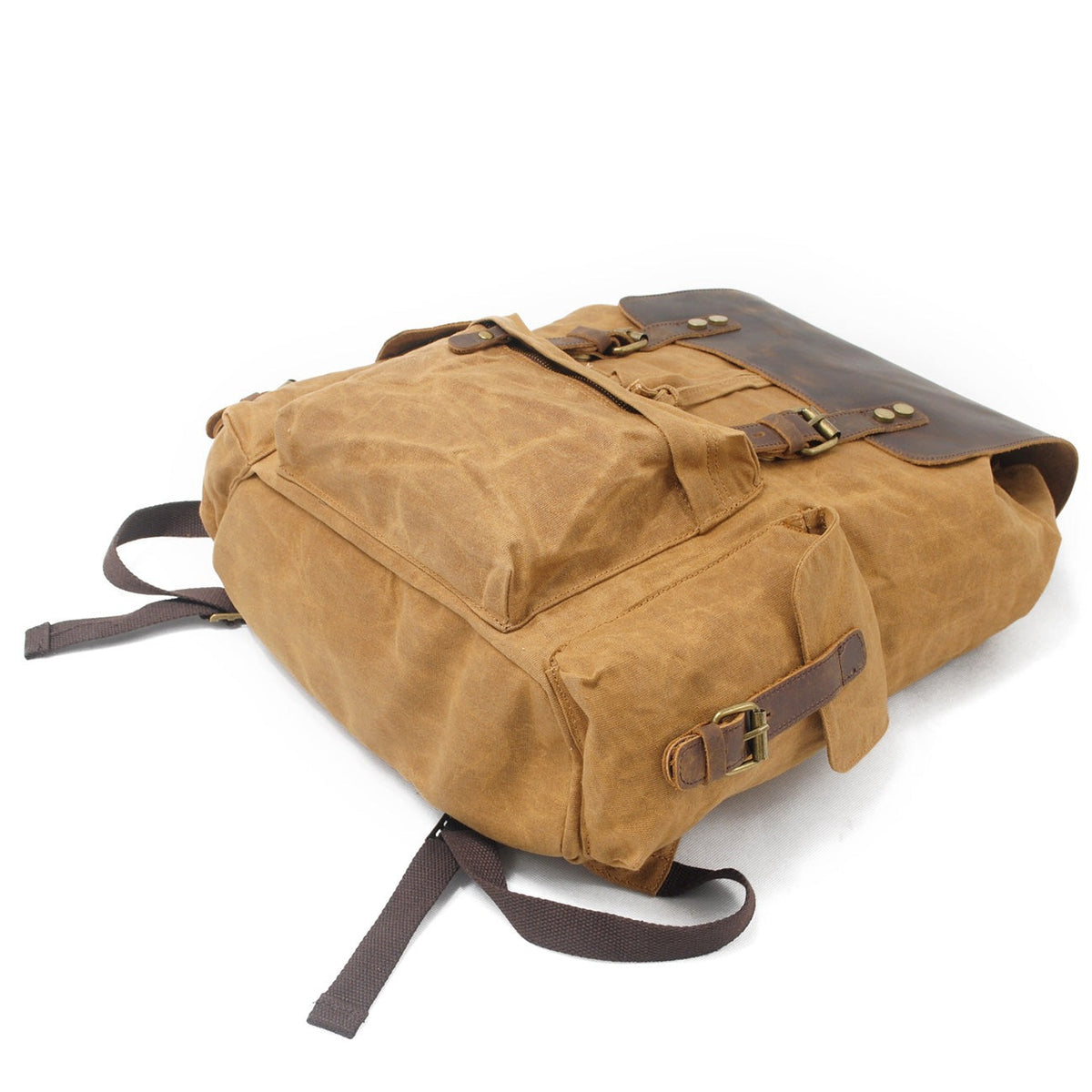 Khaki waxed canvas backpack showing its exterior side pocket and leather buckle.