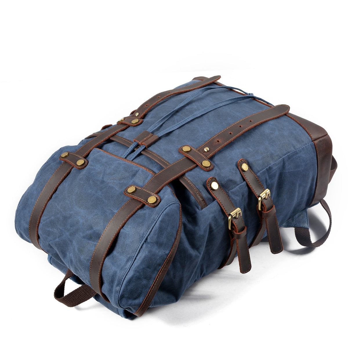Blue waxed canvas rucksack showing the side pocket and leather straps.