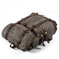 Gray waxed canvas rucksack lying flat with straps fastened