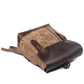 Khaki backpack lying flat with the leather flap and front zipper pocket
