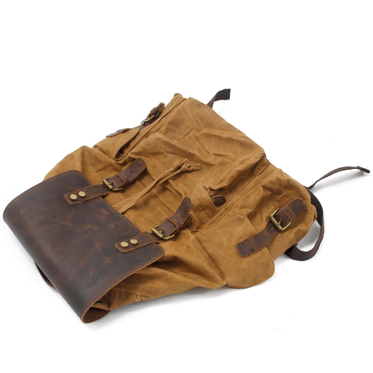 Khaki rucksack lying on its side with the flap folded over
