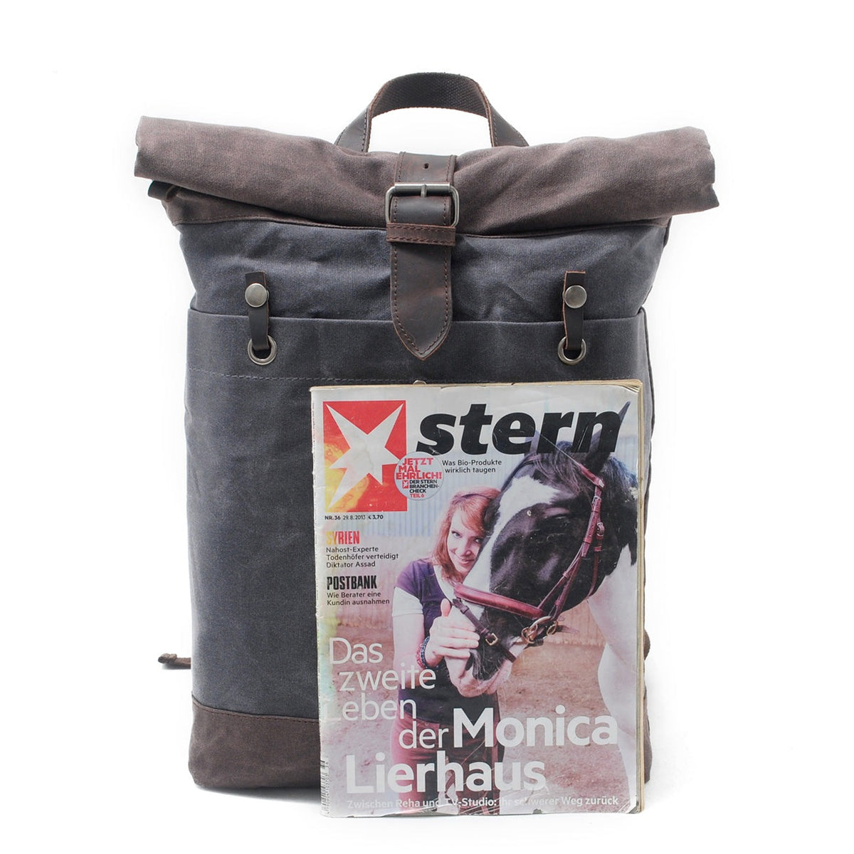 Gray backpack next to a magazine to show its size