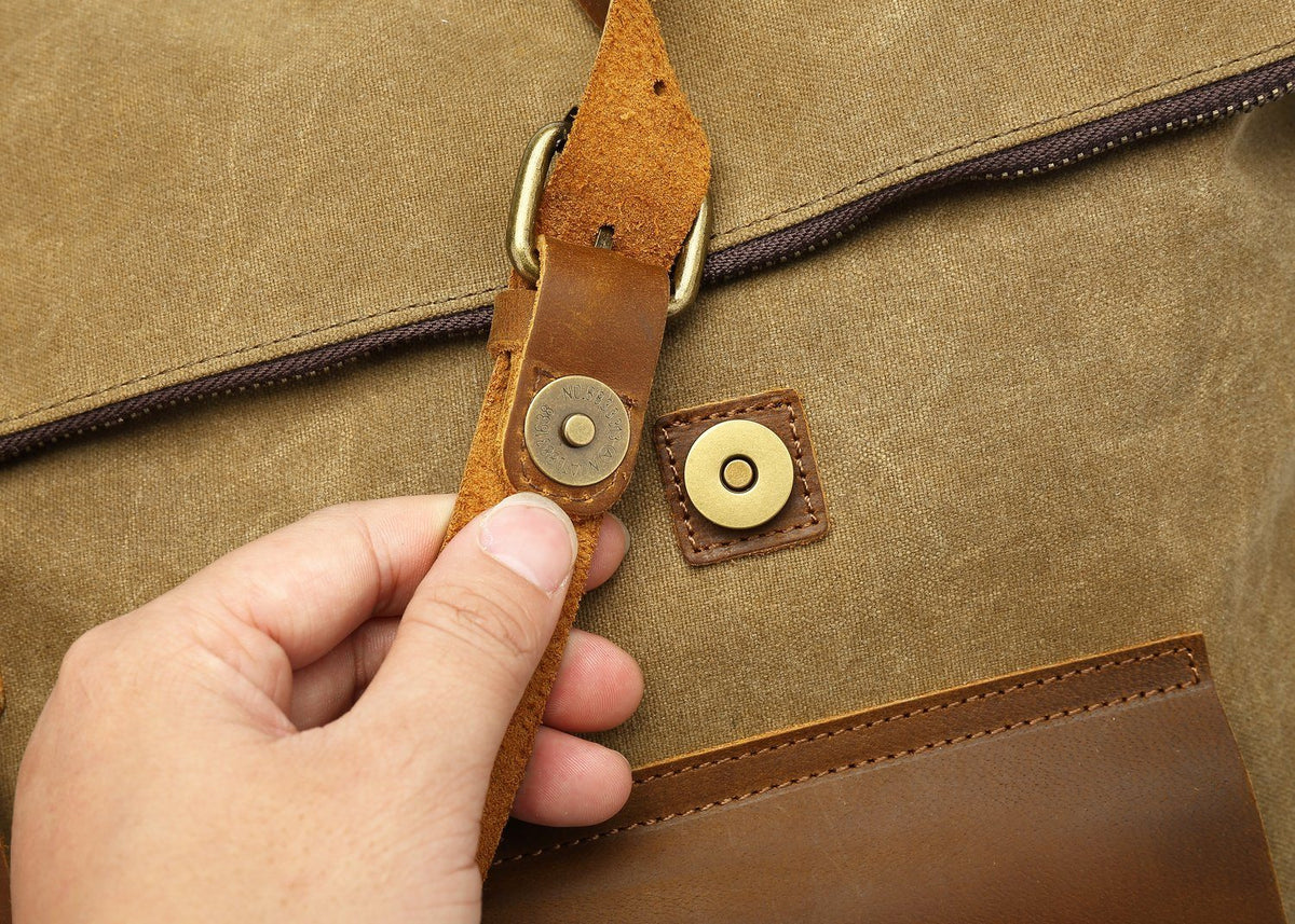 Hand opening the magnetic snap on a front pocket