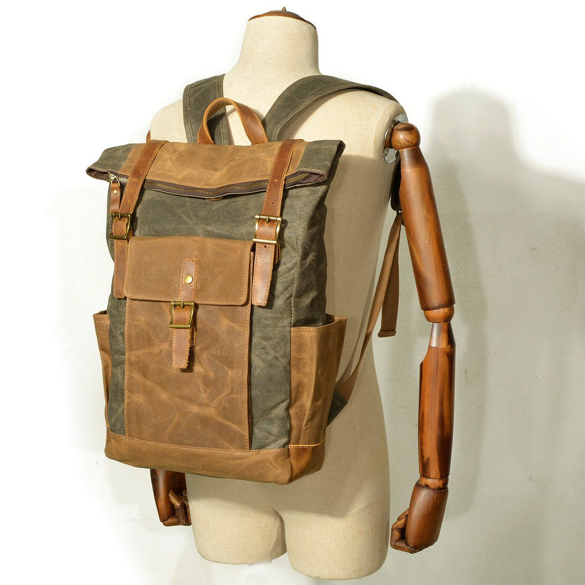 Army green rucksack worn on a mannequin to show how it sits on the back
