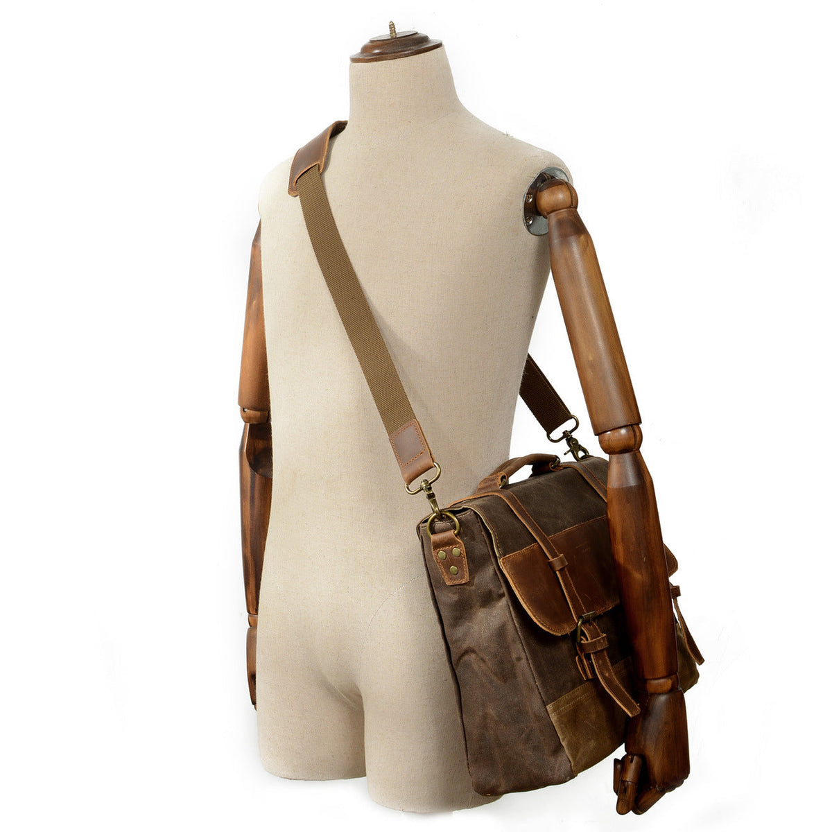 Canvas messenger bag worn across a mannequin's body to show the strap position and bag size