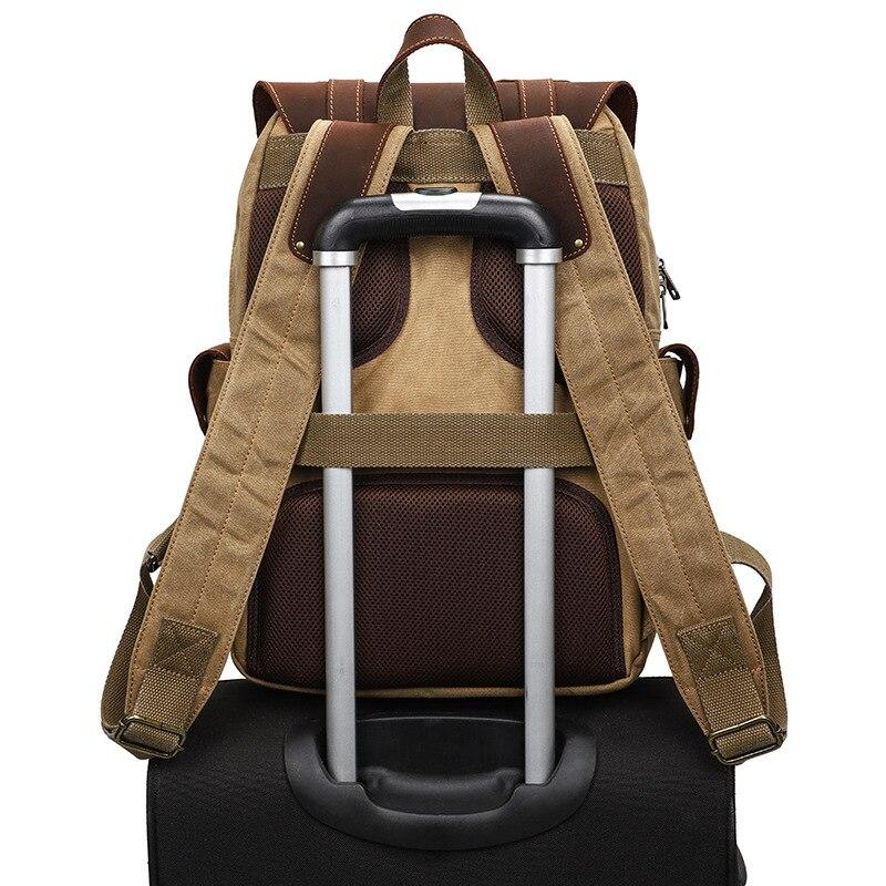Camera backpack slipped over a rolling suitcase handle with its luggage strap