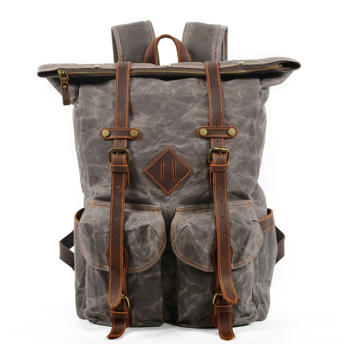 Front of gray waxed canvas backpack with top rolled closed and leather fastening straps secured.