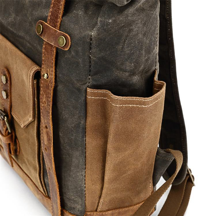 Gray waxed canvas backpack side bottle pocket with leather trim.