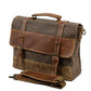 Canvas messenger bag standing beside its detached shoulder strap