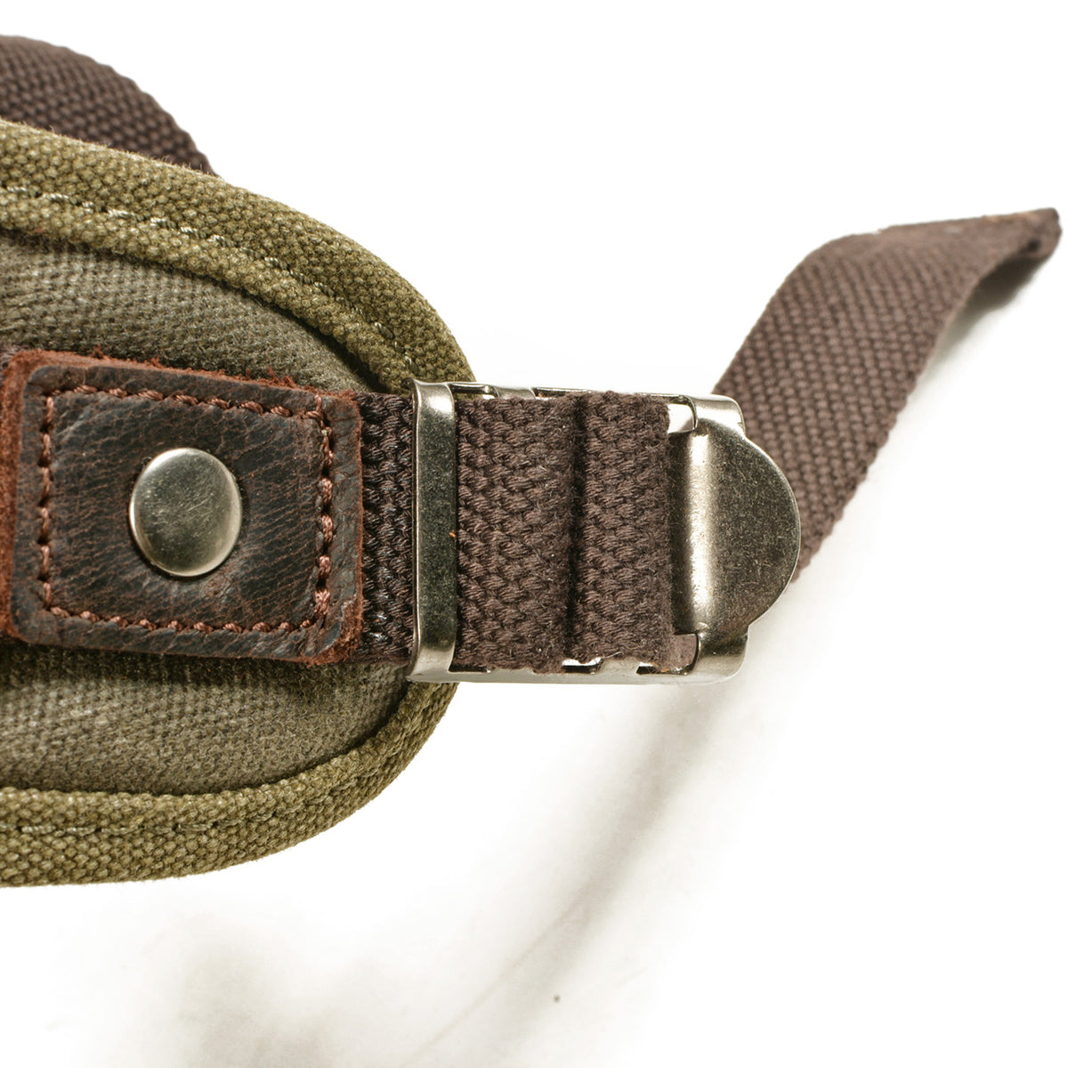 Riveted shoulder strap and metal slider on the army green backpack