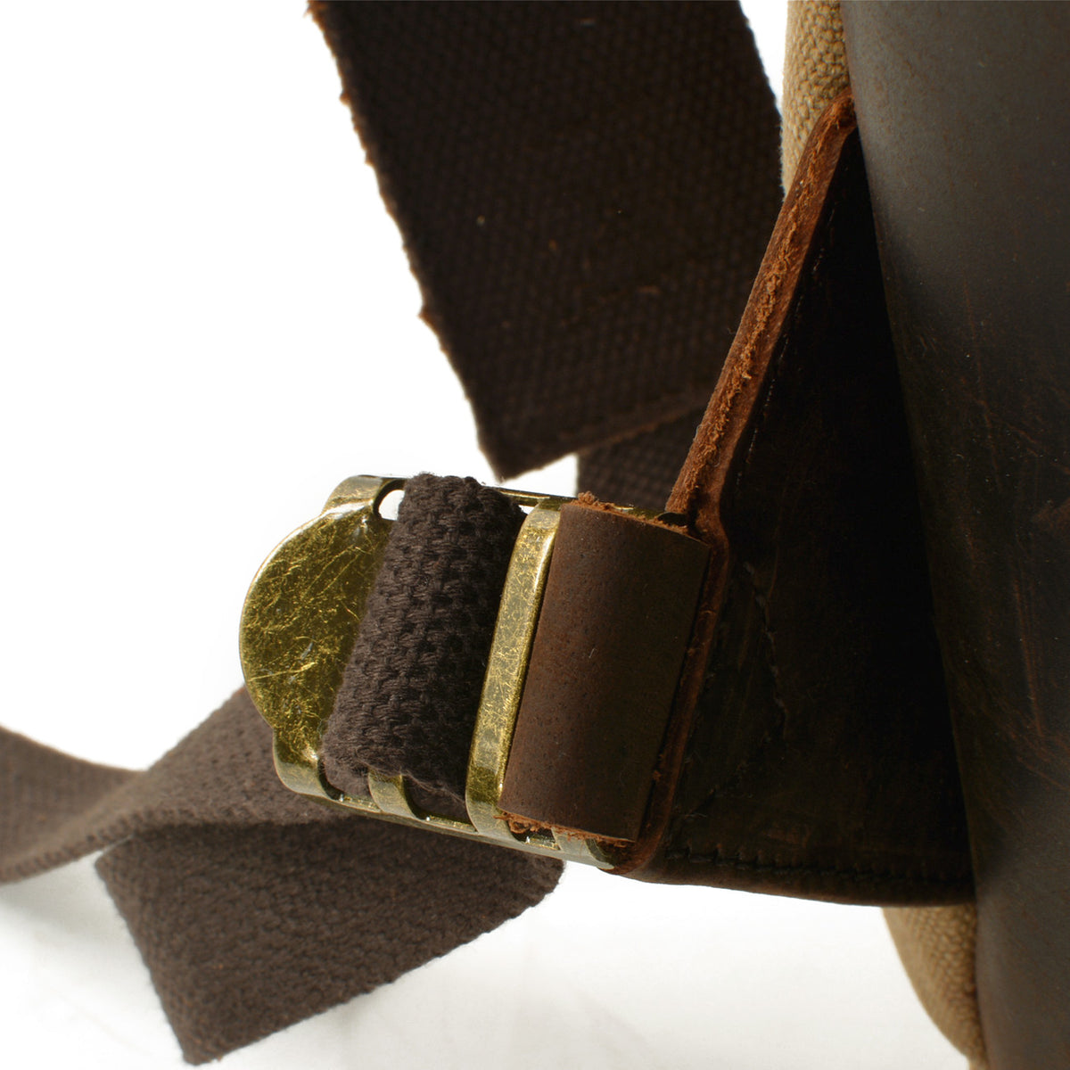 Close-up of the brass shoulder strap adjuster and stitched leather attachment