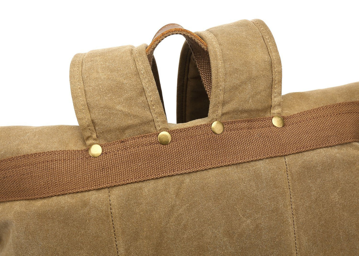 Riveted leather tabs at the top of the shoulder straps