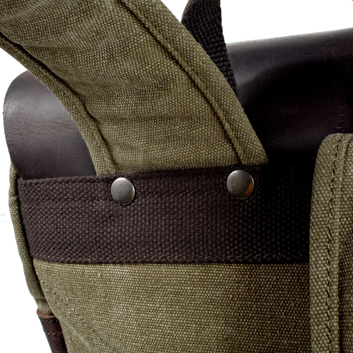 Shoulder strap attachment reinforced with a woven band and metal rivets