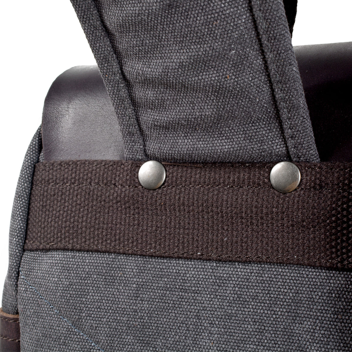 Close-up of rivets securing the shoulder strap to a woven reinforcement band