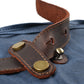 Riveted leather strap tab on Blue waxed canvas.