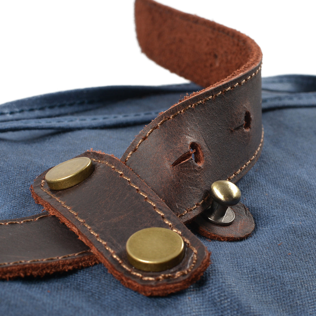 Riveted leather strap tab on Blue waxed canvas.