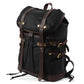 Three-quarter view of the Black waxed canvas rucksack and its drawstring top.