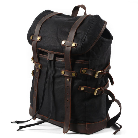 Three-quarter view of the Black waxed canvas rucksack and its drawstring top.