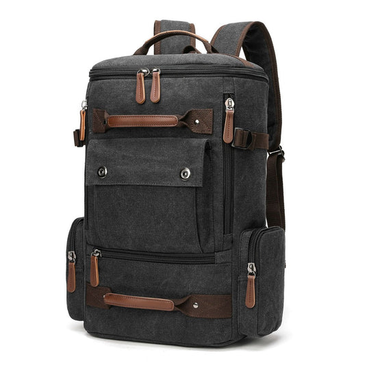 Black canvas backpack at an angle, showing side zip pocket and open front flap pocket.