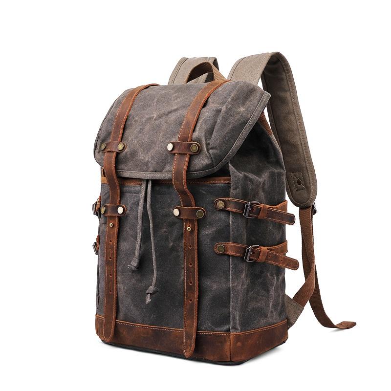 Three-quarter view of the Gray backpack with its drawstring top and side straps.