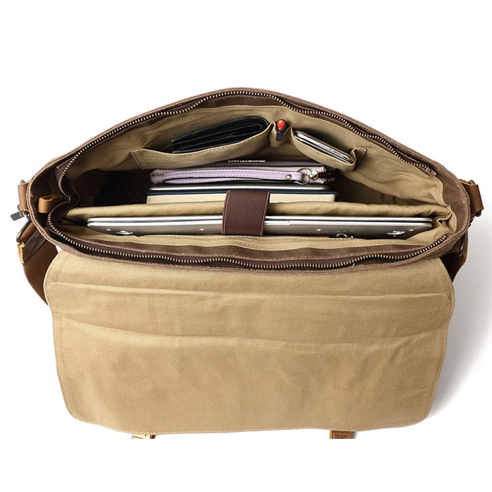 Laptop and books held by the sleeve strap, with a phone, wallet and pen in the inner pockets