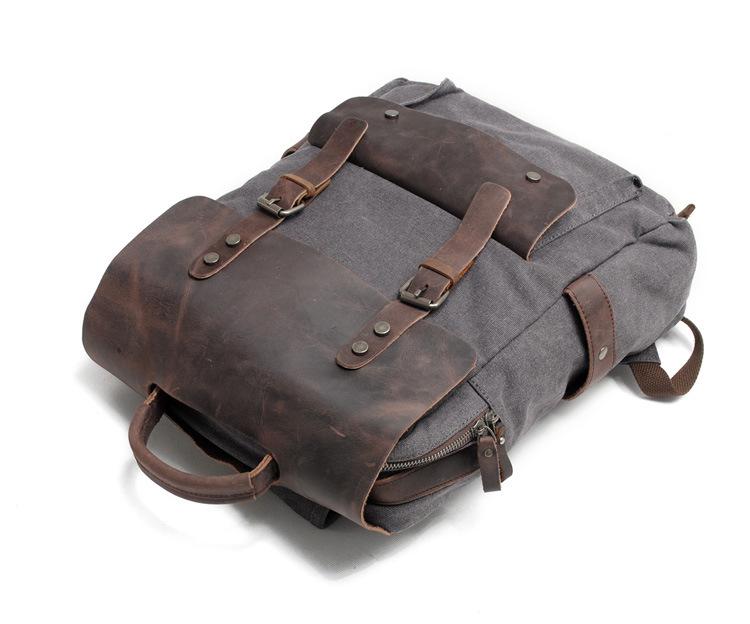 Dark Gray canvas rucksack showing the zipper and front pocket.